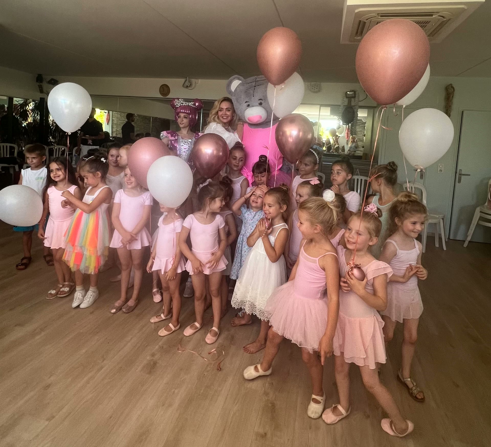 Tatiana Samoshkina with her young ballet students holding pink and white balloons after an end-of-season celebration in Nice
